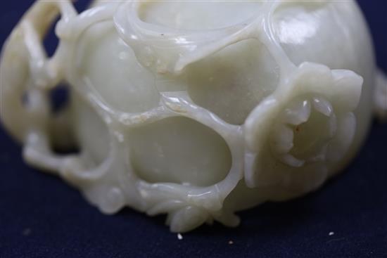 A Chinese pale celadon jade lotus cup, late Ming dynasty, W.13cm, associated wood stand